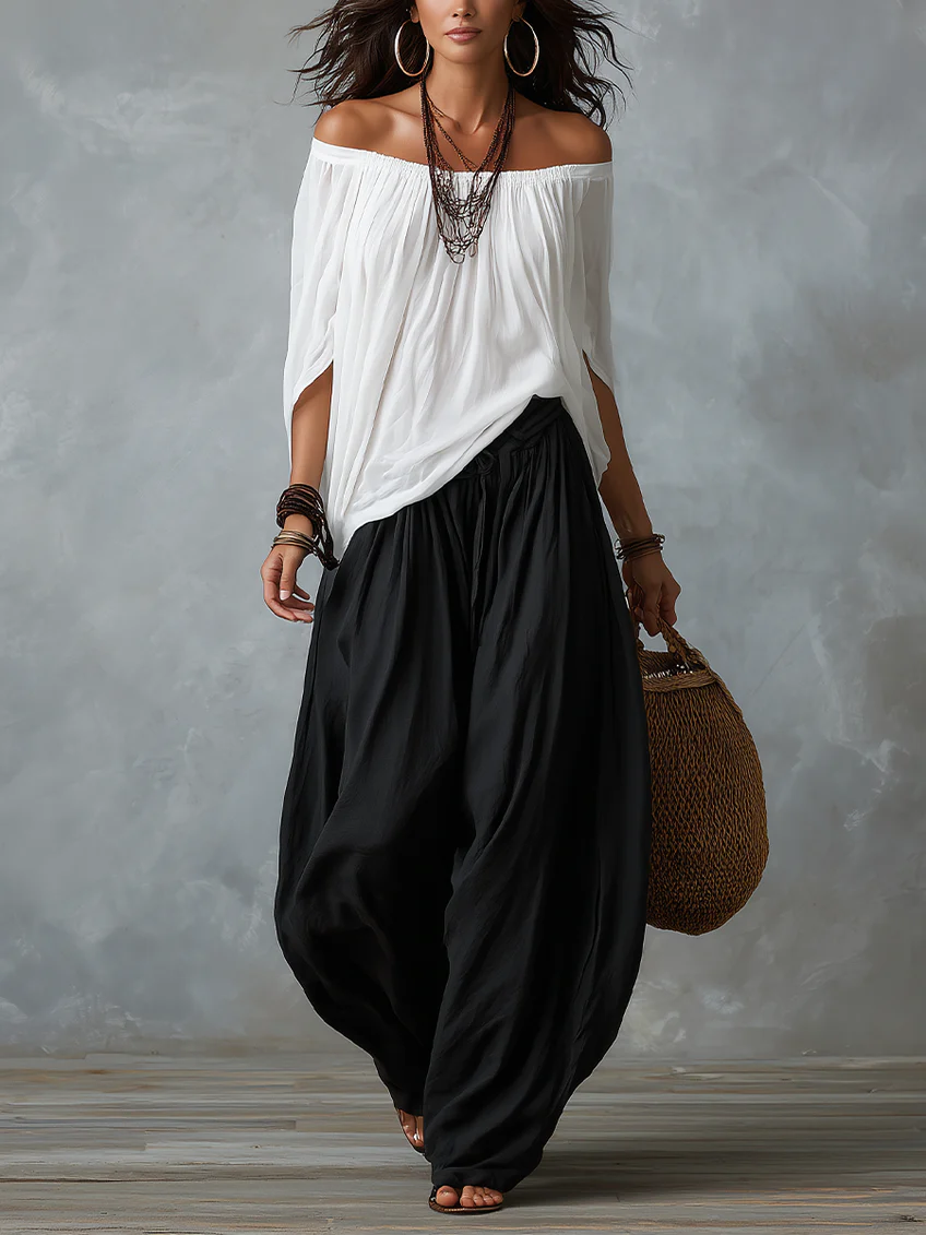 Completo con top bianco a spalle scoperte e pantaloni a zampa stile lanterna
